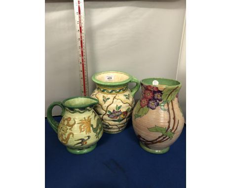 THREE CHARLOTTE RHEAD CROWN DUCAL JUGS AND VASE, GREEN, CREAM AND YELLOW TONES 