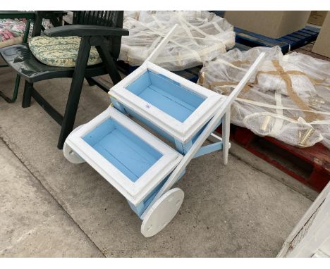 A WHEELBARROW STYLE PLANTER 