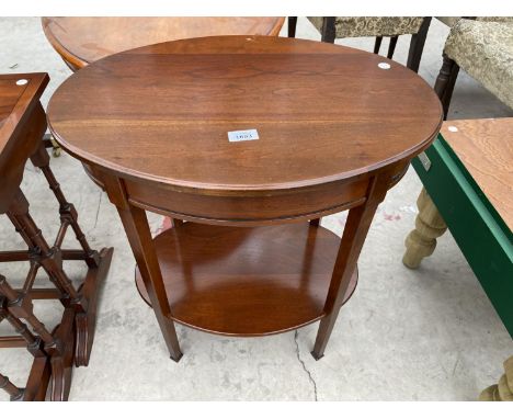 AN OVAL MAHOGANY SIDE TABLE WITH LOWER SHELF 