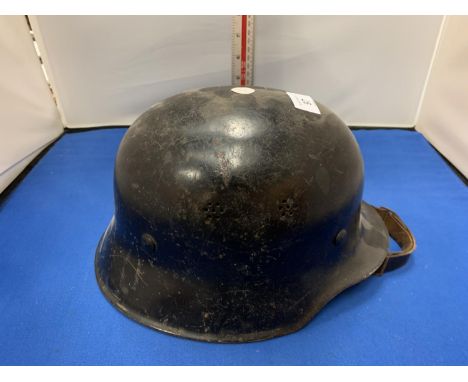 A GERMAN MILITARY HELMET WITH INNER LEATHER LINING 