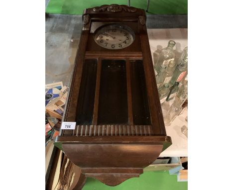A VINTAGE WOODEN CASED WALL CLOCK 