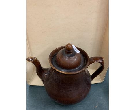 A LARGE TREACLE GLAZE TEAPOT 