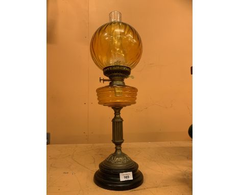 AN AMBER GLASS OIL LAMP 