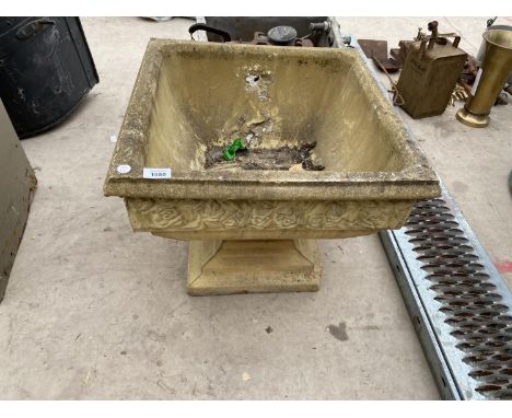 A LARGE CONCRETE PLANTER 