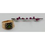 1 Brosche WG 18ct. mit Brillanten bis zu ca. 0,2ct. ca. D 3,2mm und Rubinen, Gesamtlänge ca. 5,4cm