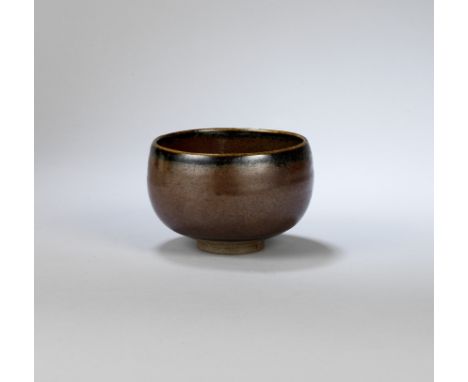 BERNARD LEACH (BRITISH, 1887-1979)Early tea bowl, circa 1935Stoneware, rich lustrous red brown glaze with dark mottling.8 cm 