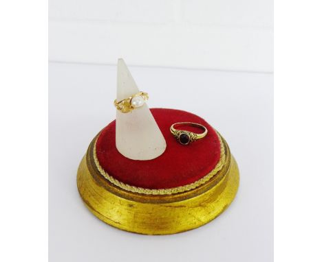 A pearl set dress ring on a yellow metal band, UK ring size L together with a garnet set ring (2) 