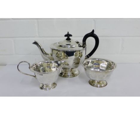 A George V silver three piece teaset comprising teapot, milk jug and sugar bowl, with makers marks for Emile Viner, Sheffield