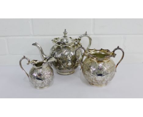 An Epns foliate engraved three piece teaset comprising teapot, milk jug and sugar bowl, all with crimpled edge and plain circ