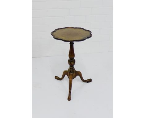 A mahogany wine table, the circular top with wavy edge, raised on tapering column and tripod supports,  48 x 50cm 