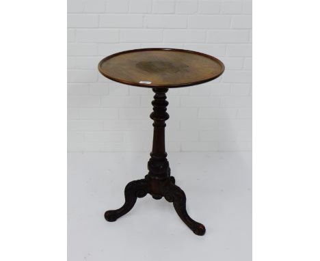 A mahogany table, the circular dished top on turned column and tripod supports, 72 x 48cm