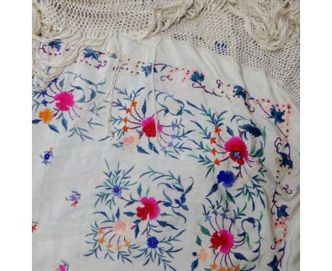 An embroidered piano shawl with long fringed border 