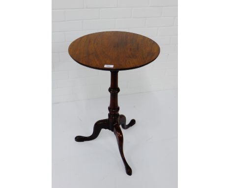 A mahogany table, the circular tilt top on turned column and tripod supports, 70 x 46cm 