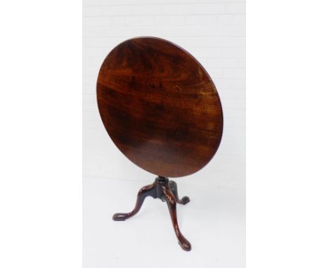 A mahogany table, the circular tilt top on carved tripod supports,  74 x 85cm 