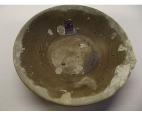 Chinese Tek Sing shipwreck olive green saucer (or oil lamp) with encrustation, numbered 7771, diameter 9cm