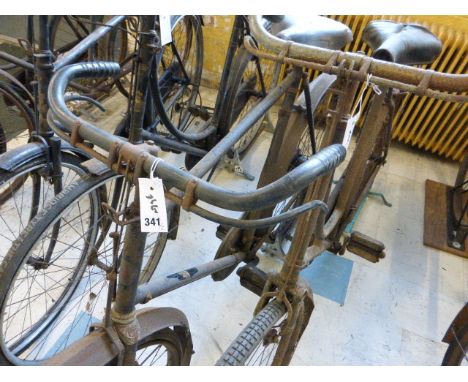 A c1905 Raleigh Lady's Bicycle. In complete condition with chain-case and rear rack, and blind fork ends. Together with a Rud