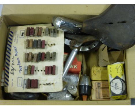 An Assortment of point-of-sale showcards, saddles, boxed 1950s lighting, etc. AF.