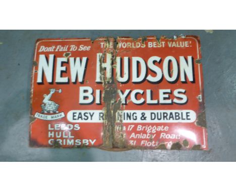 Enamel Sign.  'New Hudson Bicycles' a three-colour, single-sided hanging sign. Significant surface damage and creasing. 36 x 