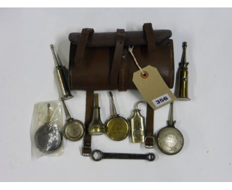 A Stout Leather Saddle Bag containing six bicycle oilers, to include a Lucas example and a Sunbeam spanner. (8)