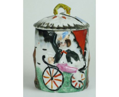 A Tobacco Jar.  French earthenware style, jar and lid labelled 'Tabac', having an embossed depiction of a rider astride a Dra