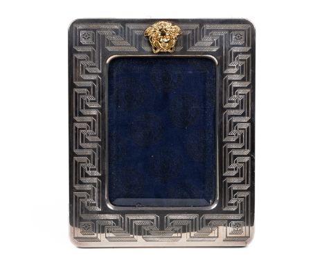 A Gianni Versace silver photograph frame With etched Greek keystone engraving and gilt Versace Medusa mask.27cm x 22cmQty: 1L