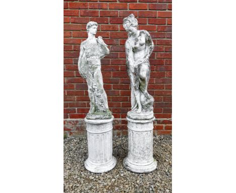 Two white painted cast reconstituted stone garden sculptures and plinths One sculpture depicting Venus, the other David after