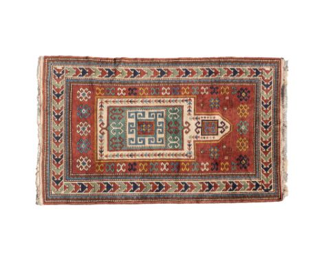 A 20th century Kars Kazak rug Of Fachralo prayer mat design, with a central Mihrab on a rust ground with a guarded border.212