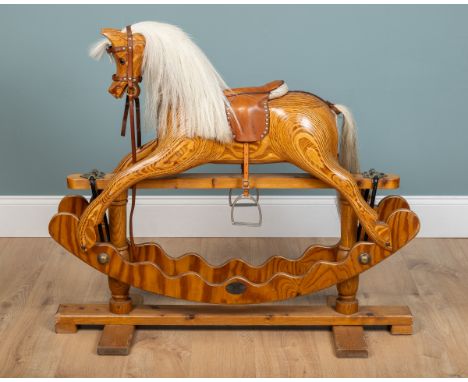 A pine rocking horse by Ian Armstrong of Hetton-Le-Hole Raised on a sledge base.112cm wide x 40cm deep x 96cm highQty: 1In ge