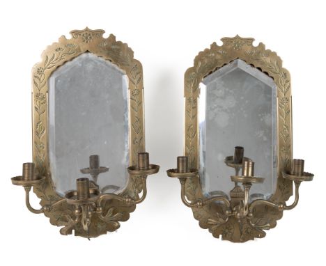 A pair of late 19th century Arts & Crafts brass girandole mirrors or sconces Each with a flower cast frame around a shaped mi
