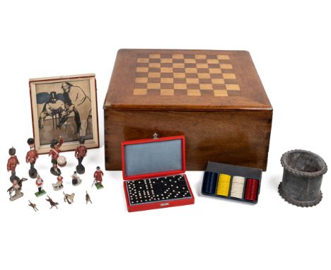 An antique games box and items within The walnut games box with a lifting lid set with a chessboard. The items within to incl