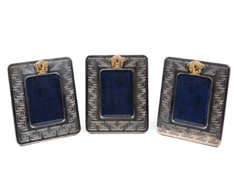 Three Gianni Versace silver photograph frames With etched Greek key decoration and a gilt Medusa mask.21cm x 17cmQty: 3One wi