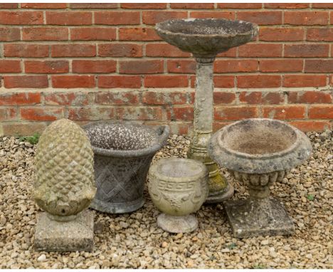 A small group of garden ornaments Consisting of an urn; a pineapple finial; a bird bath; etc. The bird bath 39cm diameter x 6