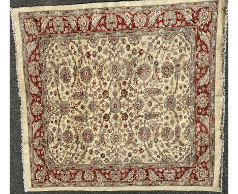 An Afghan Ziegler-style carpet With all-over foliate and pelmet decoration on a cream ground with a red ground guarded border