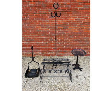 A group of wrought iron items To include a black iron boot scraper; a similar boot stand; coat hanger with horseshoes; and me