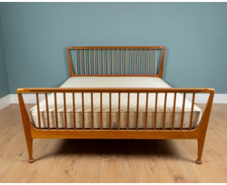 A mid-century teak-framed double bed by Loughborough Furniture retailed by Heals The bed with a flared footboard and headboar