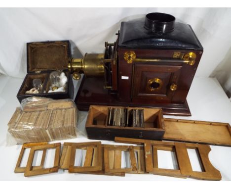 A Victorian Magic Lantern a.k.a. an Optical Lantern, a fitted wooden box containing two electric light bulbs of the period, a