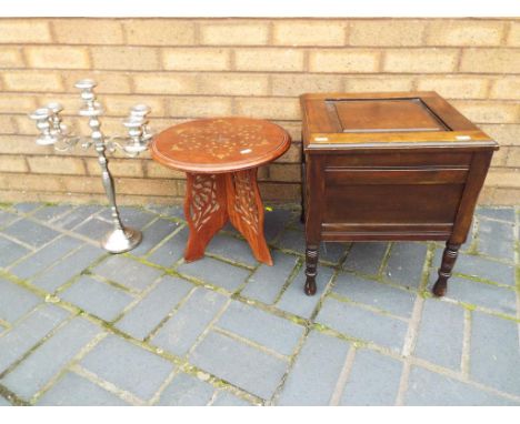 A fold-out inlaid occasional table with pierced decoration to the legs, an oak cased commode and a plated candelabra (3). Est