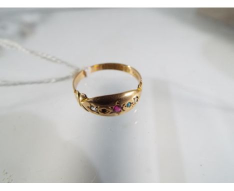 A 15ct rose gold ring, 6.5mm wide, set with five stones comprising central Ruby, two Turquoise and two spinels, all star set 