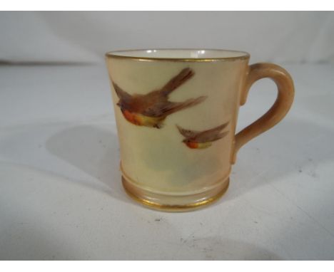 Royal Worcester - A miniature ceramic tankard by Royal Worcester decorated with Robins in flight. Approximately 4 cm (h)