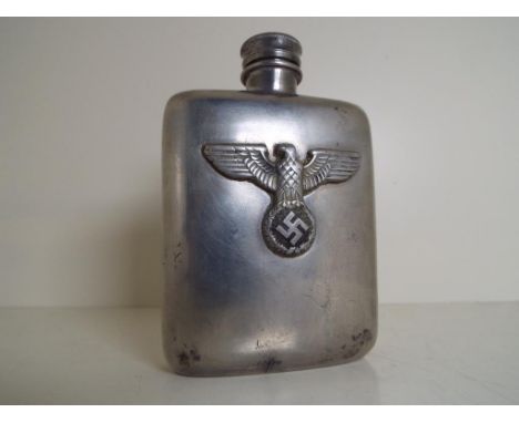 A white metal cigarette flask with screw top and bearing an applied plaque with eagle, swastika and wreath decoration, 12 cm 