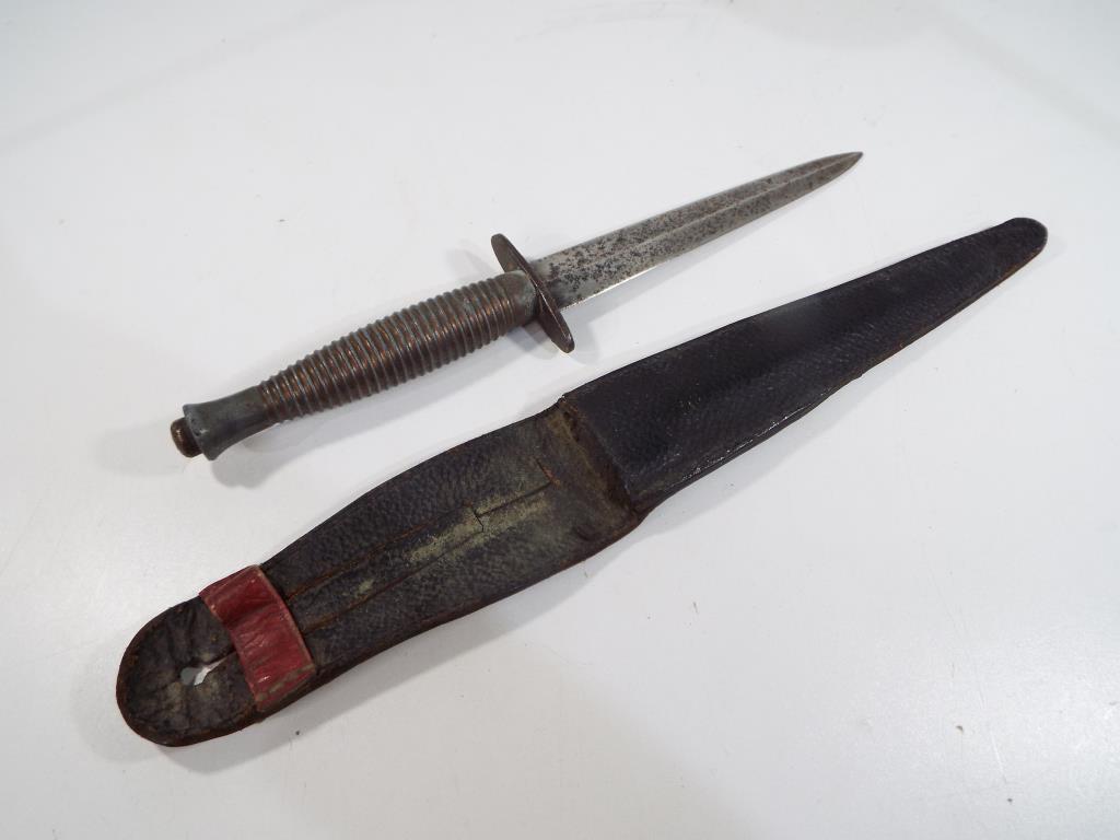 A third pattern WW2 FairbairnSykes fighting knife (SAS knife) unmarked with brass handle in orig A third pattern WW2 FairbairnSykes fighting knife (SAS knife) unmarked with brass handle in orig