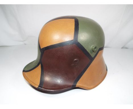 A World War Two (WW2) German Army helmet with impressed mark inside SI.66 with fitted leather interior, hand-painted with cam