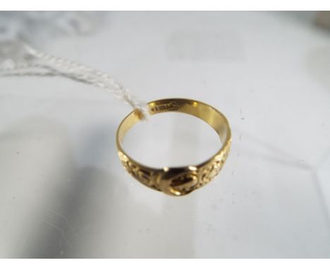 A 9ct gold , 6.5mm wide engraved tapered buckle ring, size M, approx weight 1.82 grams Est £30 - £50