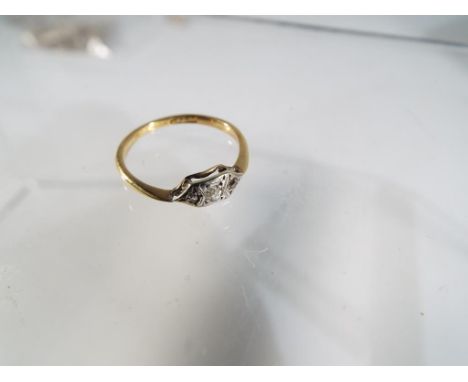 A 18ct yellow gold diamond ring, comprising of three illusion set , old cut diamonds, all set in a rectangular plate on a yel
