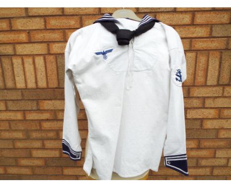 A World War Two (WW2) German Kreigsmarine (Navy) white summer tunic and neck tie with applied patch badges. Estimate £60 - £1