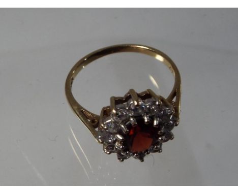 A lady's 9 carat yellow gold cluster ring set with garnet and cz, size O + 1/2, approx 2.67 gm (all in) - Est £30 - £50 