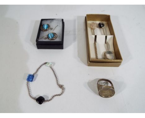 A fused glass and sterling silver bracelet marked 925, a pair of white metal earrings, a silver ring stamped 'silver' and a s