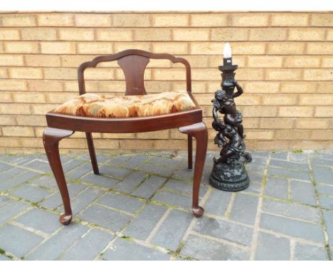 A good quality piano stool and a lamp in the form of 2 cherubs.