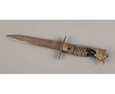 A World War II Italian Fascist youth dagger, gilded brass eagle head pommel and black wooden wire bound handle, without scabb