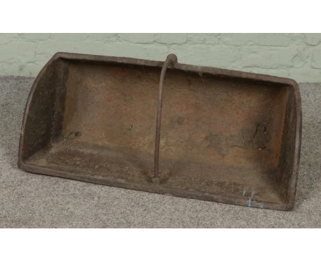 A large cast iron feeding trough with central division raised on four small feet. Approx. dimensions 76cm x 37cm x 32cm.